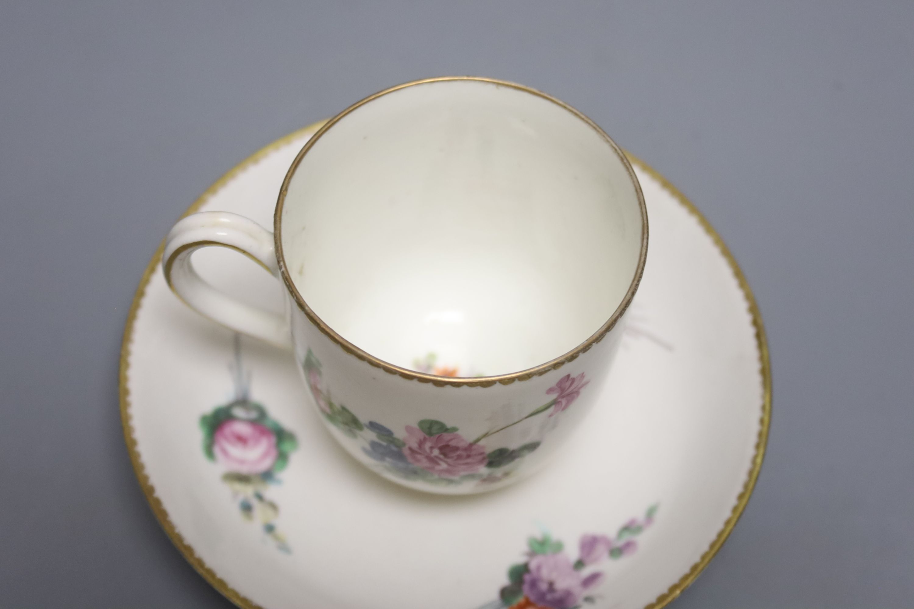 A large Derby coffee or chocolate cup and saucer painted with sprays of flowers by Wm. Billingsley,